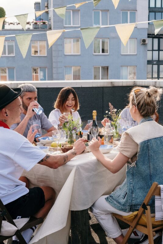 group of people sitting on chair in front of table
